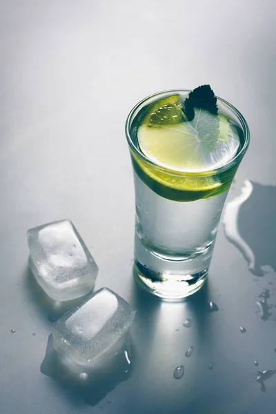 Pieces of ice for cooling a glass of vodka