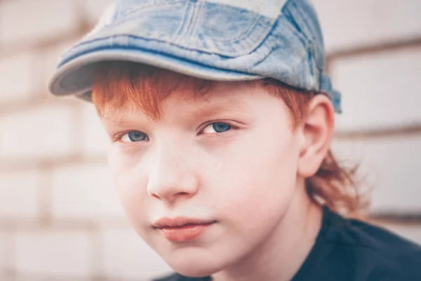 Red-haired boy bully with a determined look