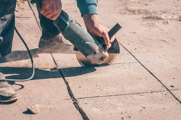 Worker Saws Asphalt Angular Grinder Diamond Disc Carrying Out
