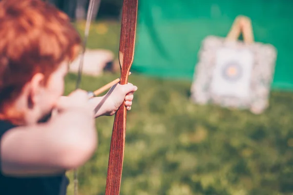 Redheaded Boy Aiming Target Bow Arrow — Stock Photo, Image