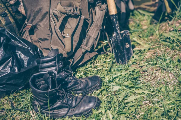 Army equipment, military boots, backpack and shovel