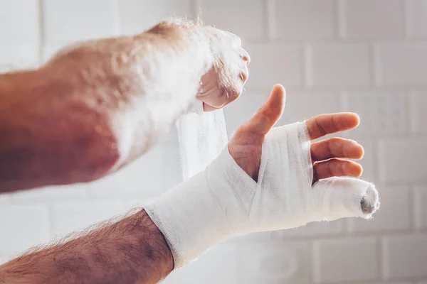 Emergency first aid - bandage on hand with plaster and bandage
