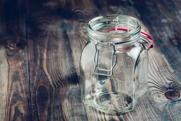 Empty glass jar on a wooden table - utensils for food
