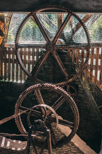 Old water drive with belts and gears from a wooden water wheel - inside view