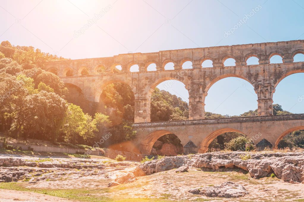 The view from the banks of the river Gardon on the arched stone bridge of Pont du Gard - perspective