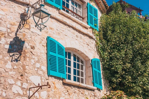 Vintage windows in a stone wall of a mediterranean house