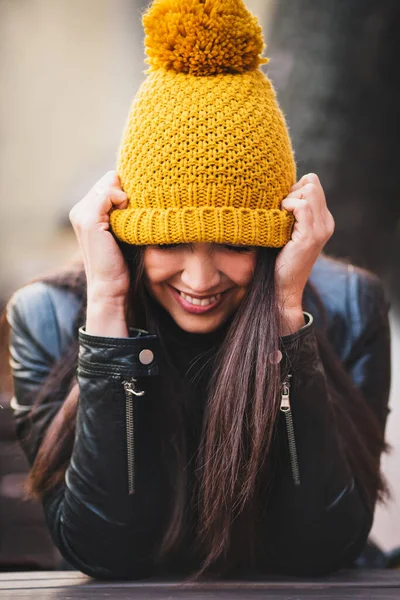 Nice Brunette Girl Pulls Warm Yellow Knitted Hat Her Eyes — Stock Photo, Image