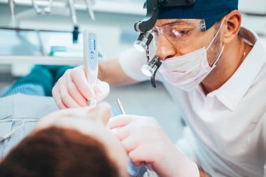 Tooth filling - The application of resin - the filling hardens after exposure to UV light, This makes them very durable