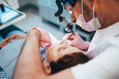 Stages of depulpation - the dentist cleans the dental canal and cauterizes the dental nerve