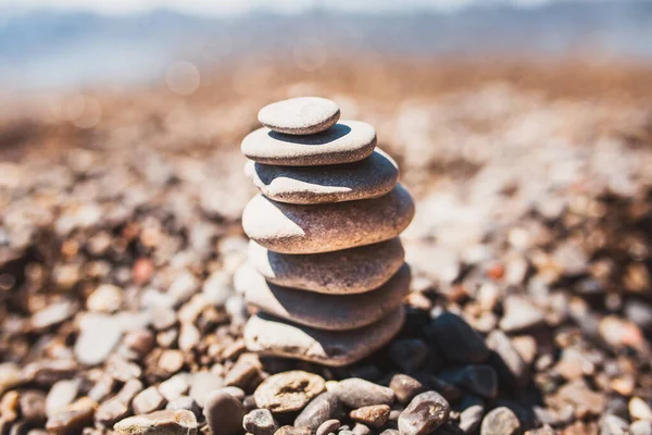 A column of stones on the shore - a symbol of balance and stability