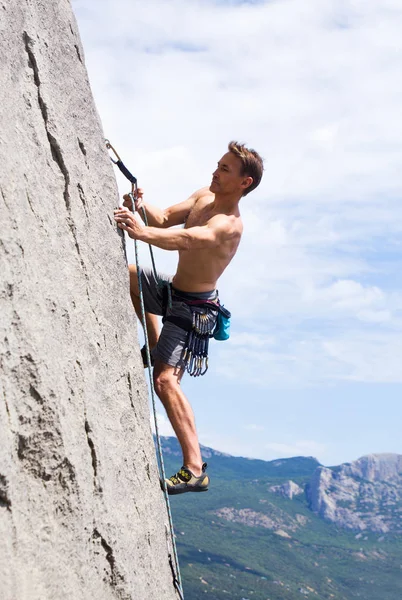 rock climber climbing an overhanging cliff