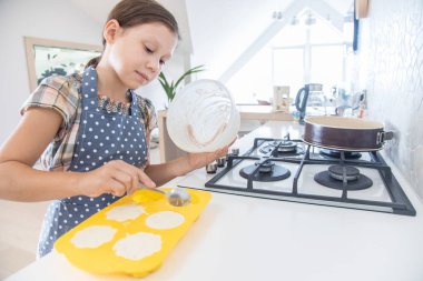  hamur için evin mutfağında bir charlock küçük kız kendini kneads