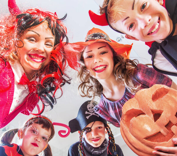 group of funny  children in costume celebrate together a halloween party