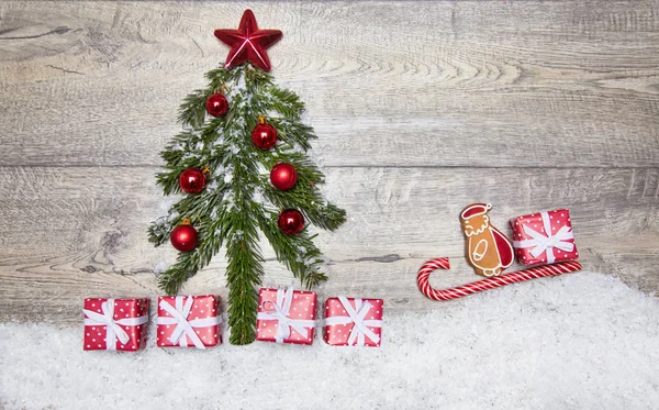 Beautiful Christmas picture of Christmas tree branches, gifts, decorations on the wooden floor. Santa on his sleigh ride to the New Year tree