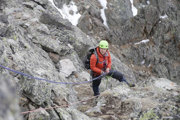 mountaineer woman climbing to  the mountain