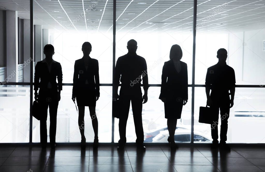 Group ofl  silhouettes of businesspeople comunications  background business centre