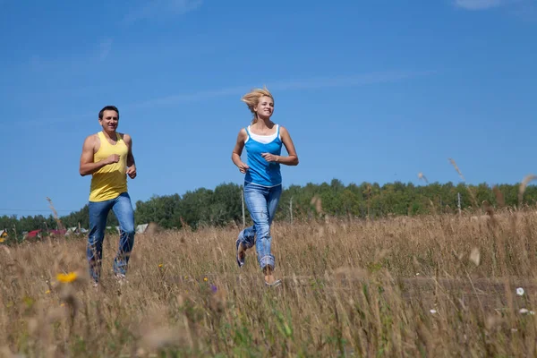 美しい中年の人々が自然の中でジョギングをし — ストック写真