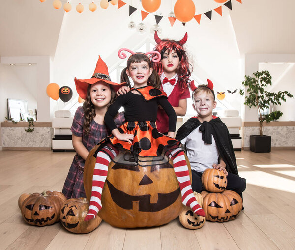 group of funny  children in costume celebrate together a halloween party