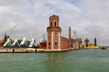 VENICE, ITALY - MAY, 09: Arms of giants come out of water and hold hands to form a bridge, powerful art installation created by Lorenzo Quinn titled Building Bridges on May 09, 201 clipart