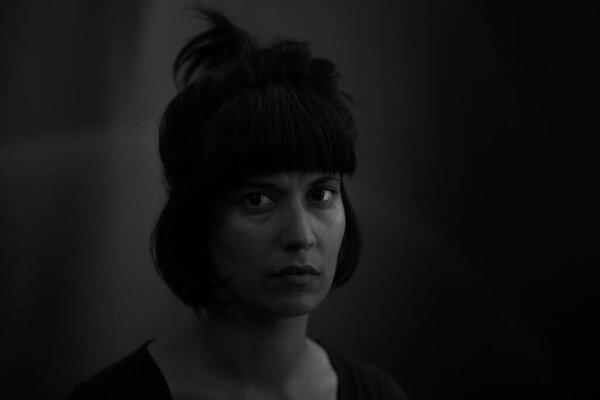 Dramatic portrait of an indian girl on black background