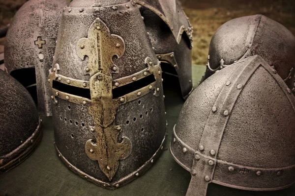 ancient knight helmets on the table