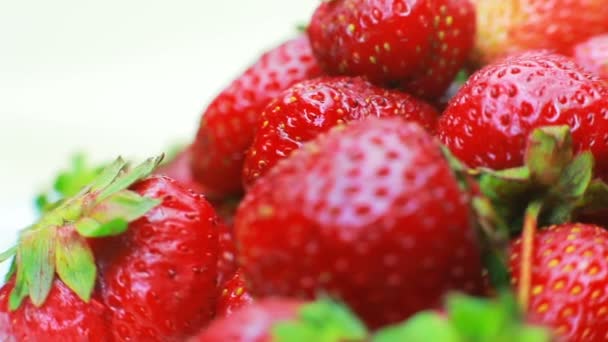 Rijpe aardbeien draait op een witte achtergrond. — Stockvideo