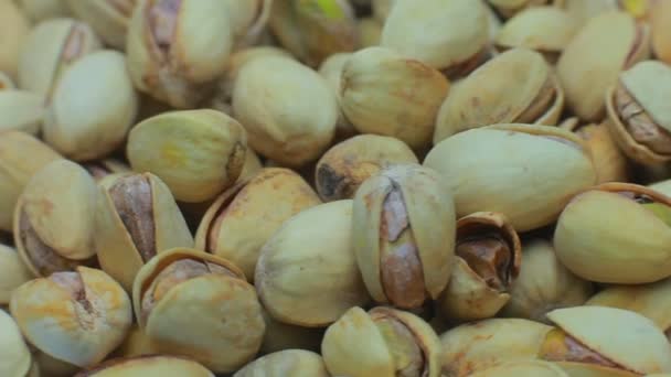 Lots of fried pistachios . On a white background. — Stock Video