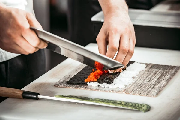 Close-up man s hands making rolls in restaurant. — Stock Photo, Image