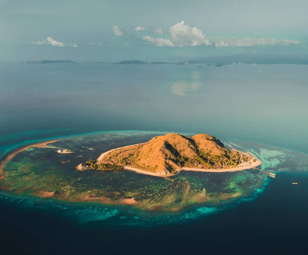 Island among the ocean. Komodo. Aerial drone shot. — Stock Photo, Image