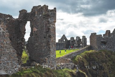 Close-up wall of now-ruined Irish Dunluce castle. clipart