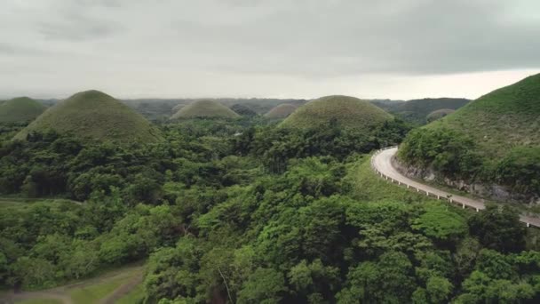 Filipiny Chocolate Hills widok z lotu ptaka: szczyty budynku na wyspie Bohol. Piękna droga na górze — Wideo stockowe