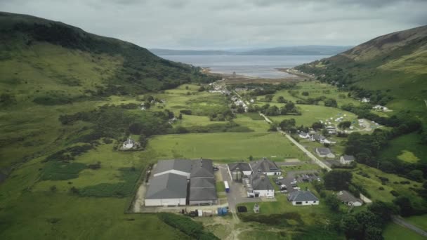 Escócia vista aérea: whiskey distillery Loch Ranza, greenery village, mountain valley, camp town — Vídeo de Stock