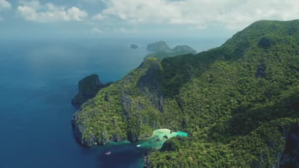Widok z lotu ptaka na górską wyspę i wybrzeże oceanu z łodziami na plaży. Lato nikt krajobraz — Wideo stockowe
