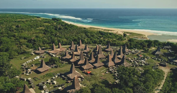 Seaside traditional village with unique designed roofs houses aerial. Indonesia tourist attraction — Stock Photo, Image