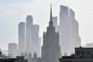 Moscow skyline. Stalinist skyscraper on the background of the Moscow City business centre skyscrapers shown after summer rain. Capital of Russia