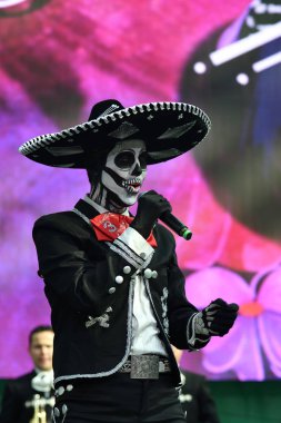 Moscow, Rusya Federasyonu - 29 Haziran 2018: Dia de los Muertos Meksika Karnaval sırasında sokakta şeker kafatası makyaj ile Meksika şapkalı adam şarkı söylüyor