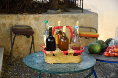Handmade holder with bottles of local white and red Greek wine for sale in village. Crete, Greece clipart