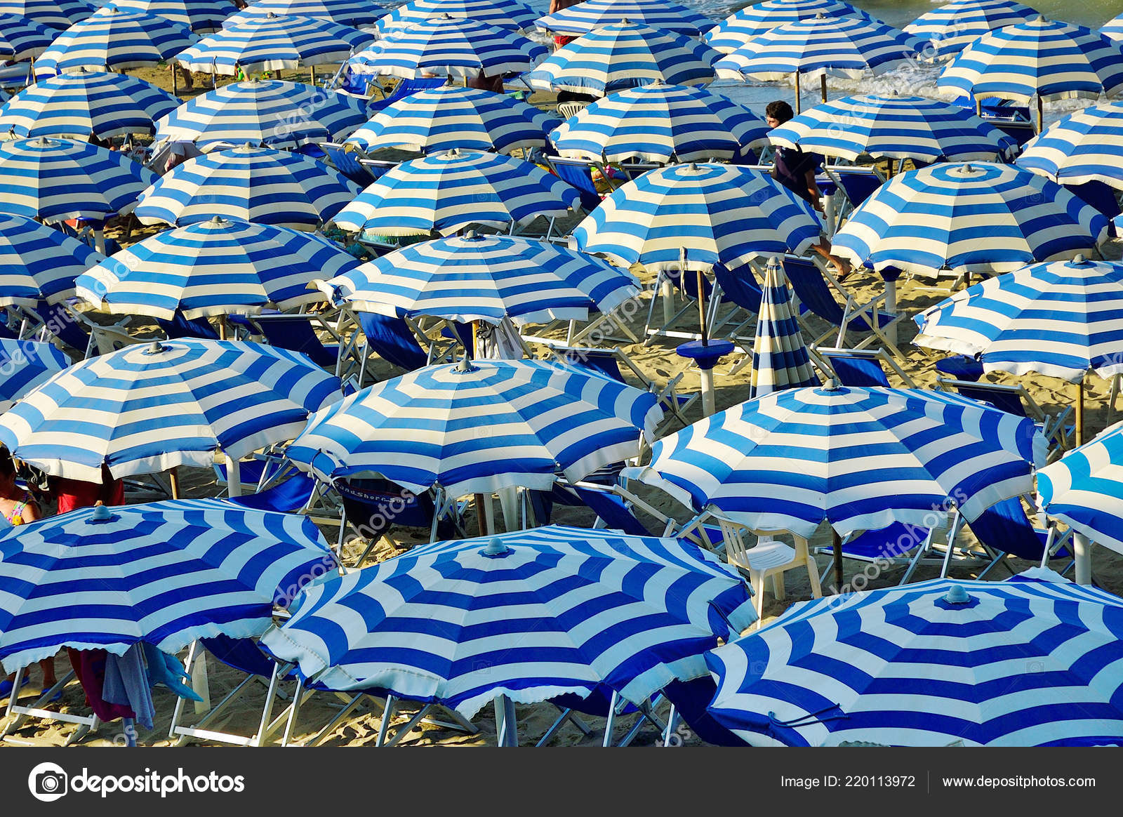 depositphotos_220113972-stock-photo-blue-white-umbrellas-montesilvano-beach.jpg
