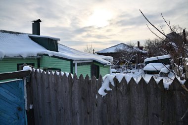 Winter in russian village, frozen wooden houses at morning time, Voronezh, Russia