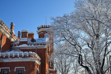 Neogotthic Oldenburg castle in winter park, Romon, Voronezh, Russia clipart