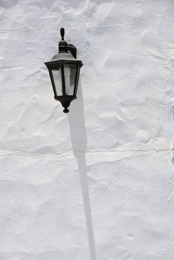 Sokak lambası ve gölgesi beyaz duvarda. Fuerteventura, Kanarya Adası. İspanya