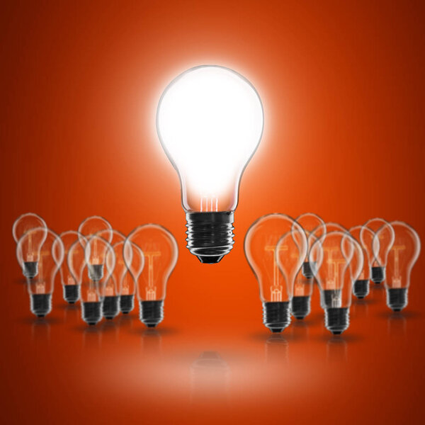 Idea and  leadership concept -  incandescent light bulb on the black background