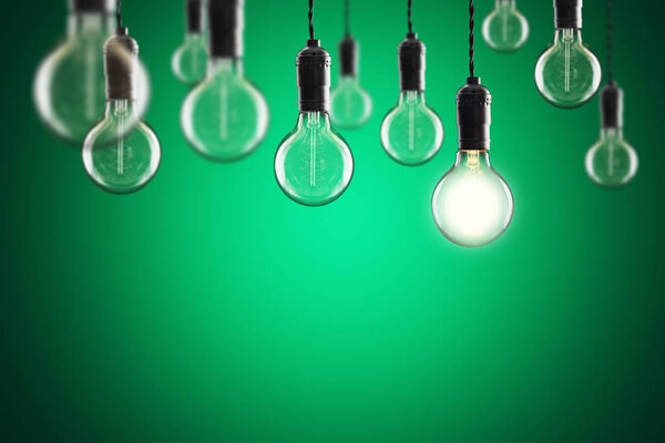 Idea and leadership concept Vintage incandescent Edison type bulbs on color wall