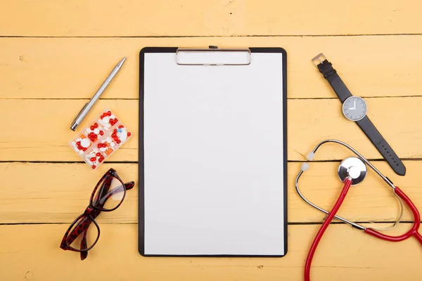 Workplace Doctor Stethoscope Other Supplies Yellow Wooden Desk Top View — Stock Photo, Image