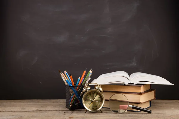 Education concept - books on the desk in the auditorium