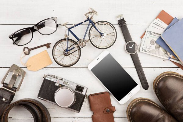 travel concept - set of cool stuff with camera and other things on wooden table