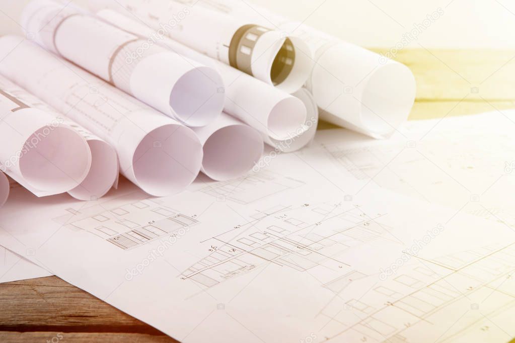 Workplace of architect - construction drawings on the table