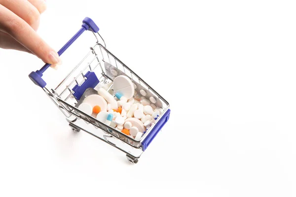 Isolated shopping cart full with pills and capsules — Stock Photo, Image