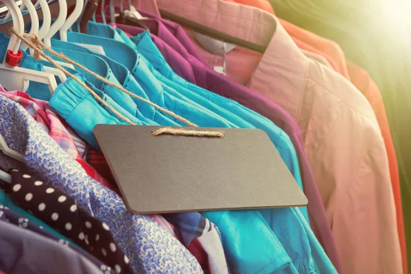 Clothes hanging on the rack in the store — Stock Photo, Image