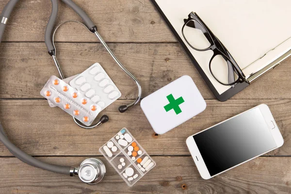 Workplace of a doctor. Stethoscope,emergency kit, and other stuf — Stock Photo, Image